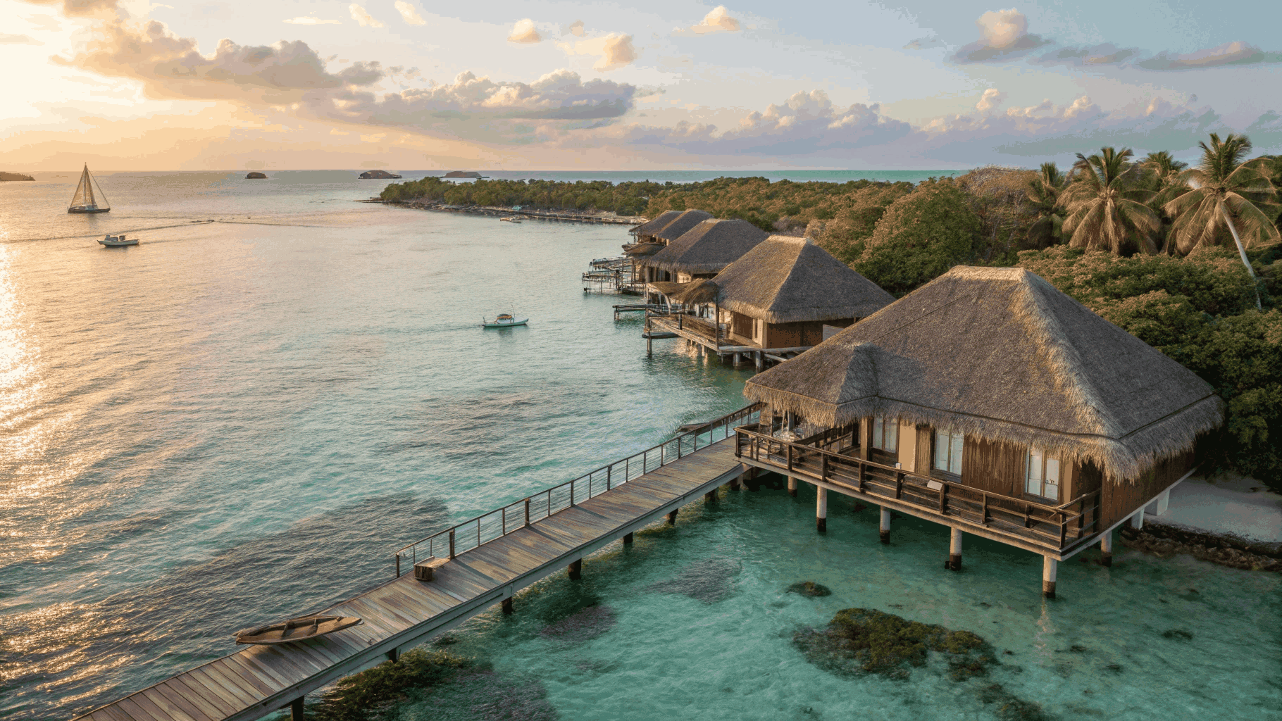 Maldives overwater villa with private sundeck and stairs into crystal lagoon arranged by Travizi